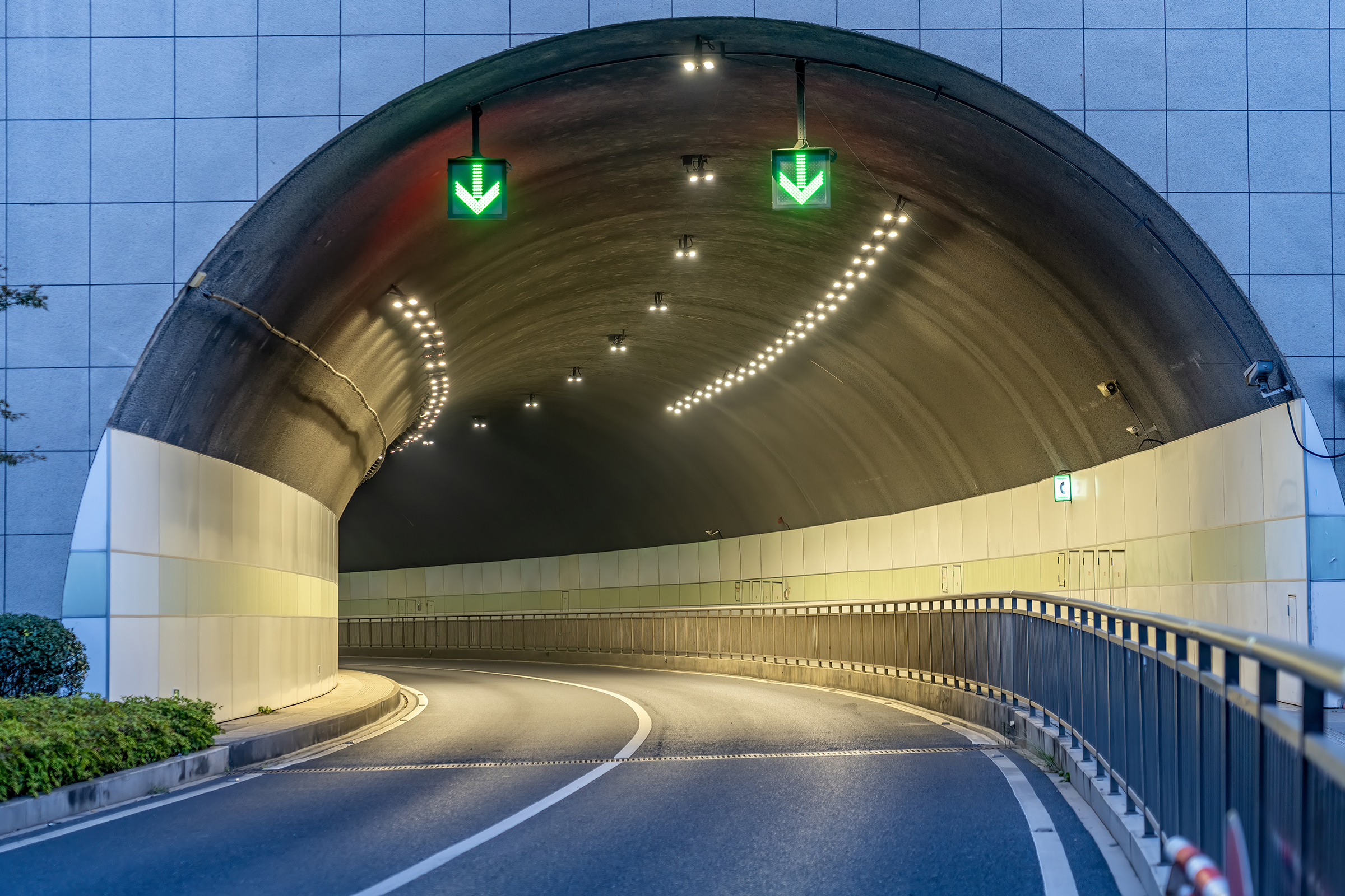 urban road tunnel with green directional lights
